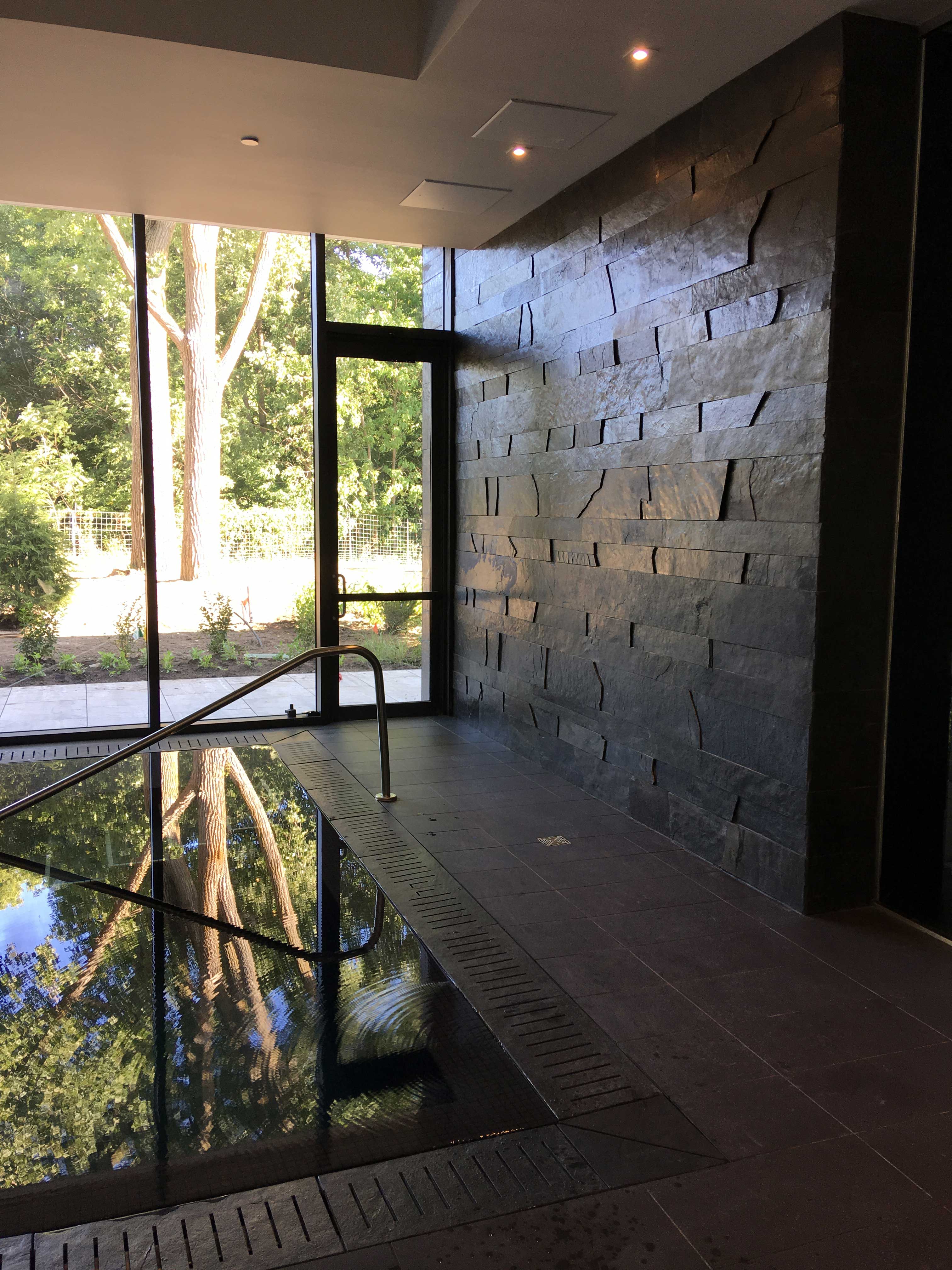 Indoor pool wall paneling and custom slate drains