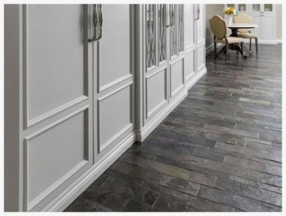 dining room with floor covered with slate board with table and chair at the end